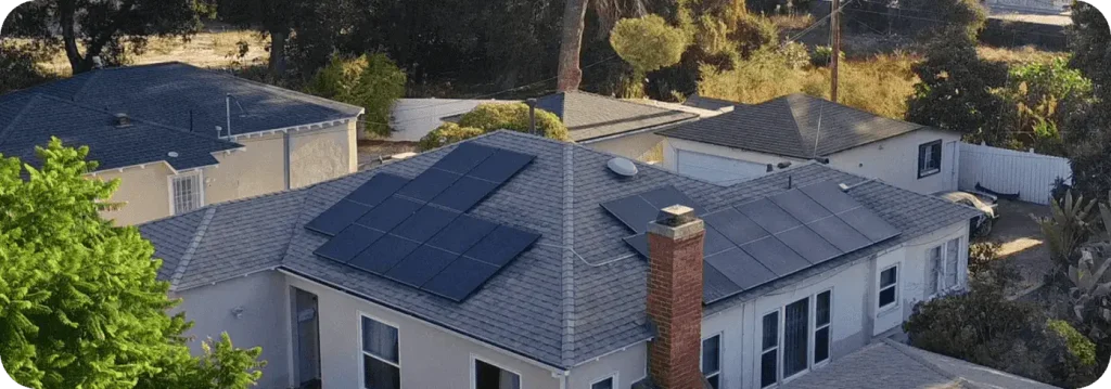 Aerial view of a house with solar panels installed on the roof.