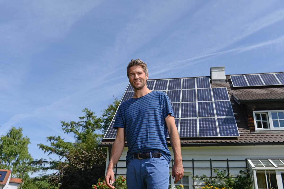 Man-Standing-Rooftop-Solar-System