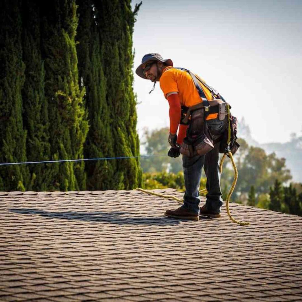 LASG tech working on a roof