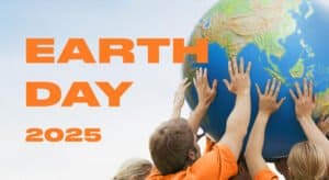 Children holding a globe for Earth Day 2025 awareness and solar energy promotion.