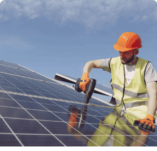 Technician installing solar panels on a sunny day for renewable energy solutions.