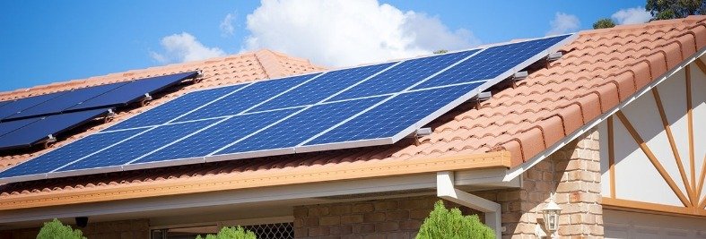 Solar panels installed on a house roof for clean energy.