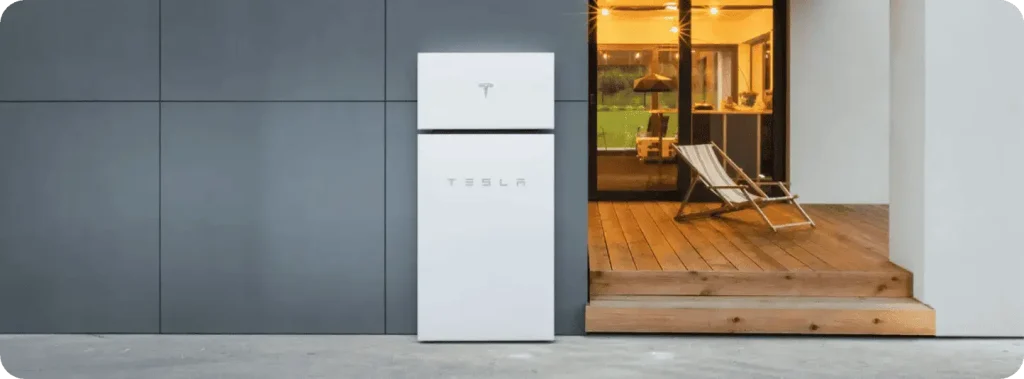 Tesla Powerwall for solar energy storage, installed outside a contemporary home.