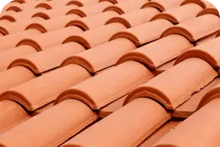 Up of terracotta roofing tiles on a house roof.