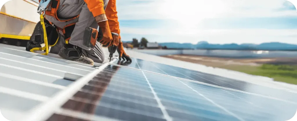 Technician installing solar panels for renewable energy solutions.